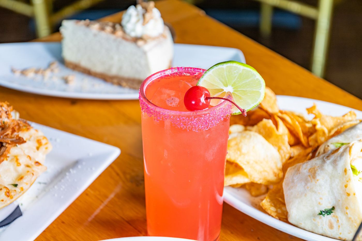 A cocktail with a sugar rim, lime and cherry at the Wyndridge bar