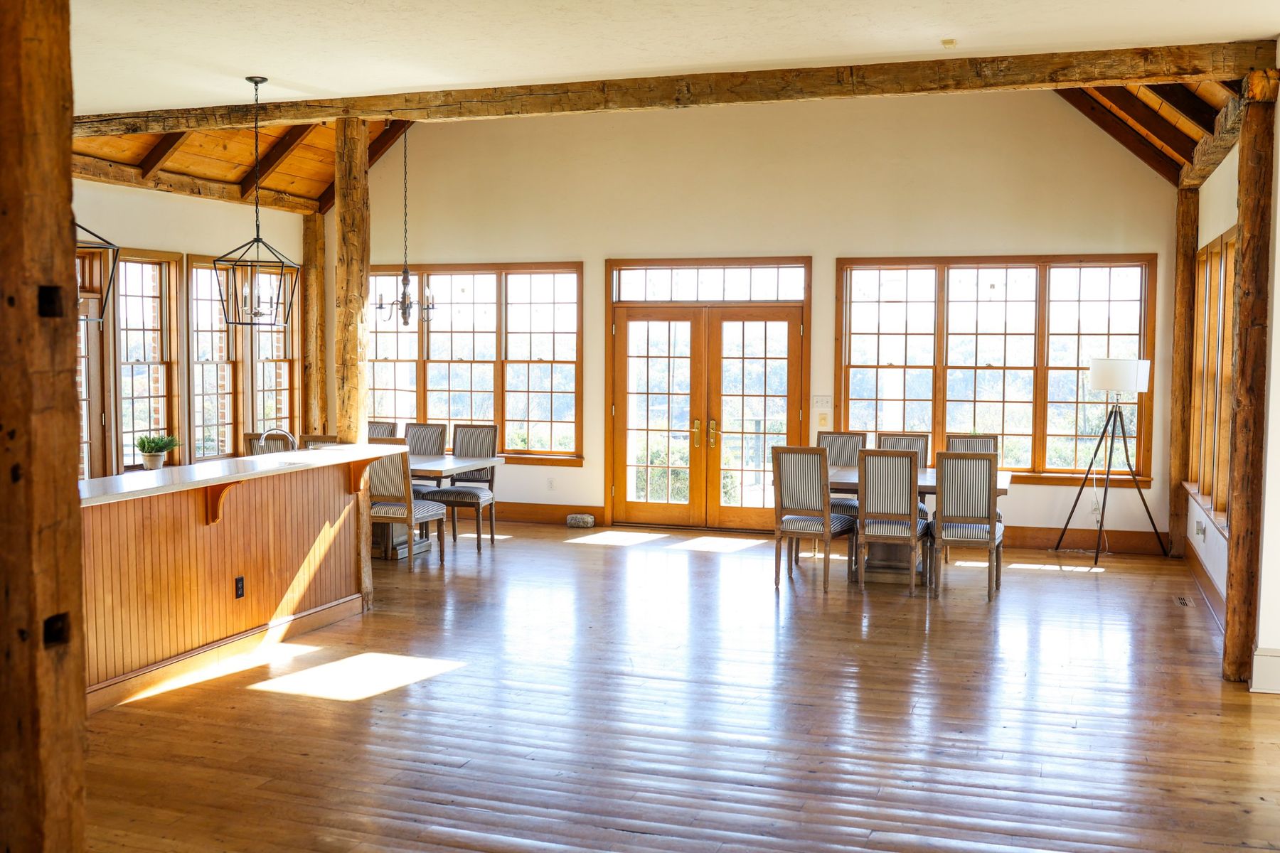 The great room with dining tables and French doors