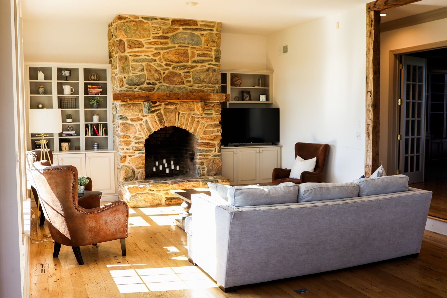 The living room with a stone fireplace