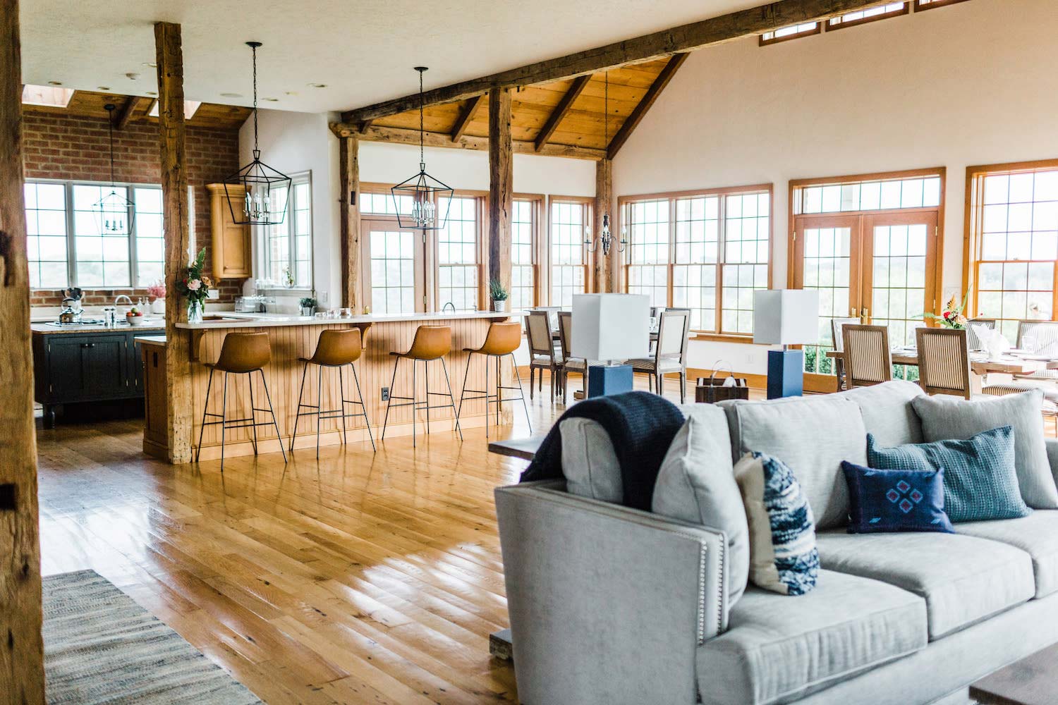 The open main living area with the kitchen island and tall windows