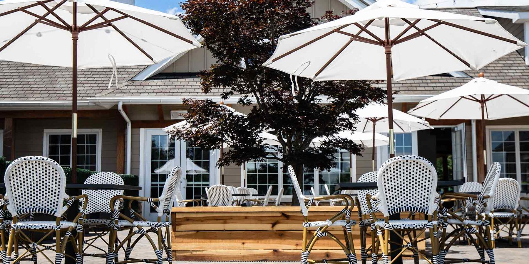 The courtyard patio with white umbrellas and bistro chairs